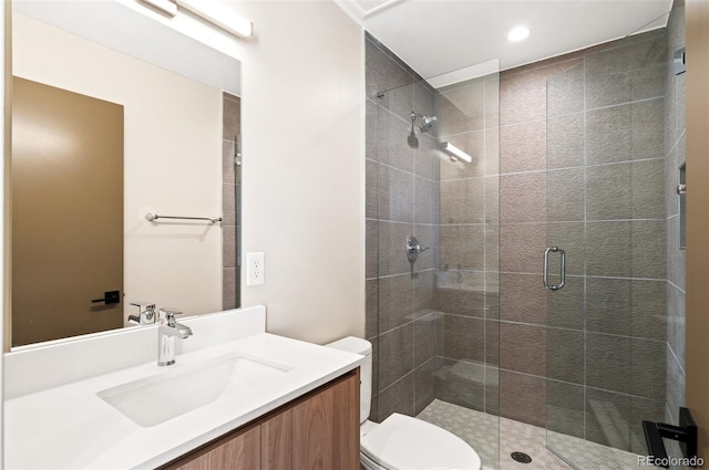 bathroom with vanity, toilet, and walk in shower