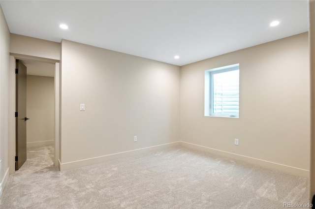 unfurnished room with light colored carpet