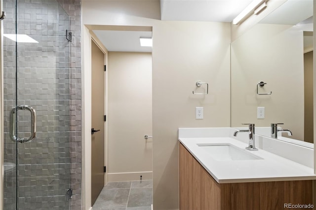 bathroom with vanity, walk in shower, and tile patterned flooring