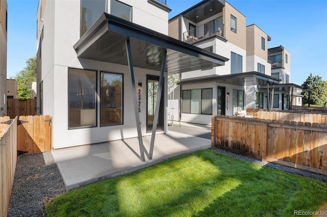 rear view of house with a yard and a patio