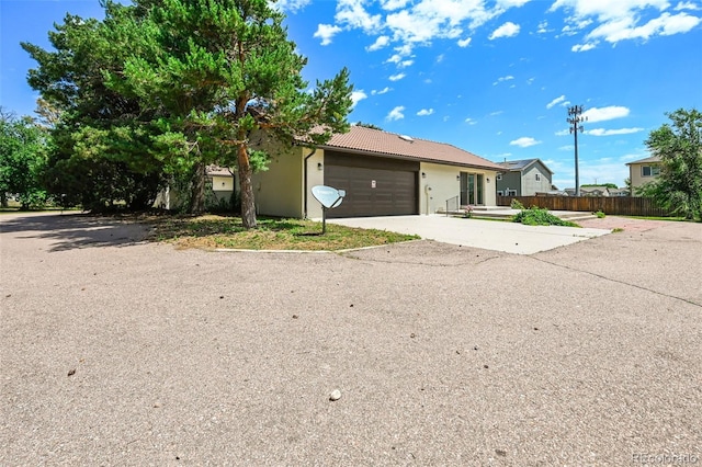 3533 Saguaro Cir, Colorado Springs, CO 80925 - single story home with a garage, concrete driveway, and a tiled roof