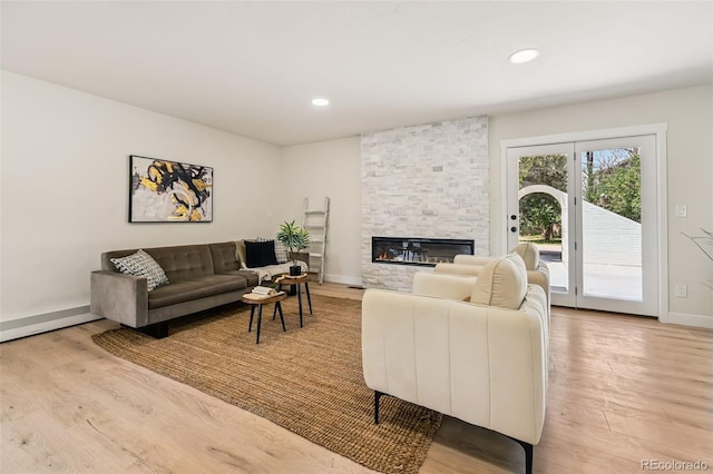 3533 Saguaro Cir, Colorado Springs, CO 80925 - living area with light wood finished floors, a fireplace, and recessed lighting