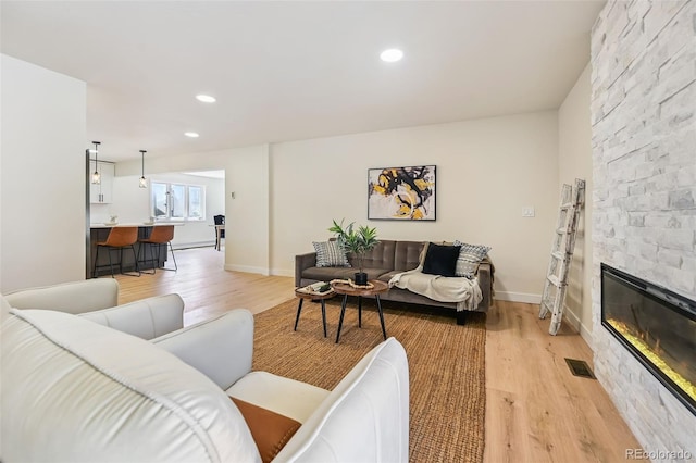 3533 Saguaro Cir, Colorado Springs, CO 80925 - living room with light wood finished floors, recessed lighting, and a fireplace