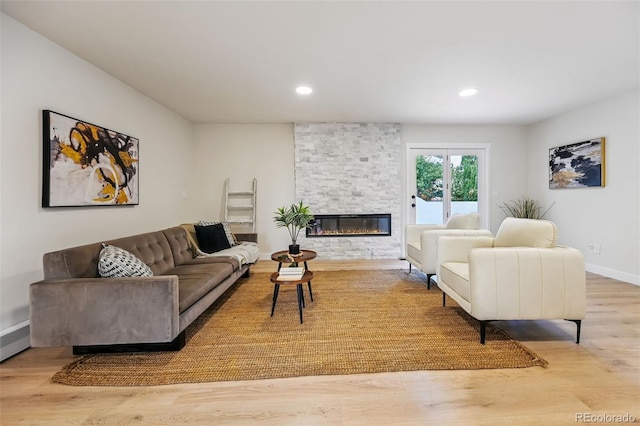 3533 Saguaro Cir, Colorado Springs, CO 80925 - living room featuring wood finished floors, a stone fireplace, and recessed lighting