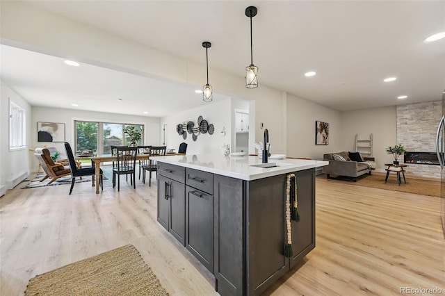 3533 Saguaro Cir, Colorado Springs, CO 80925 - kitchen featuring open floor plan, light wood-type flooring, light countertops, pendant lighting, and recessed lighting