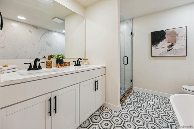 3533 Saguaro Cir, Colorado Springs, CO 80925 - bathroom with a stall shower, double vanity, a freestanding bath, tile patterned flooring, and recessed lighting