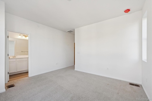 carpeted empty room featuring sink