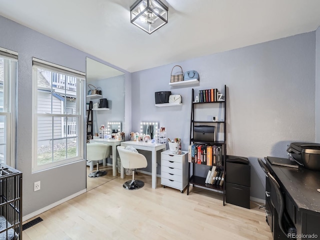 office space with light hardwood / wood-style floors and a wealth of natural light