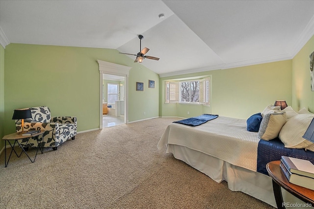 carpeted bedroom featuring crown molding, ceiling fan, vaulted ceiling, and ensuite bath