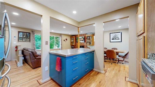 kitchen with stainless steel fridge with ice dispenser, light hardwood / wood-style floors, and blue cabinetry