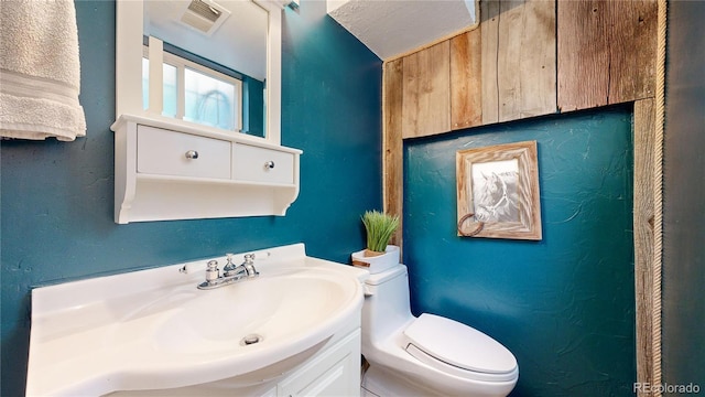 bathroom featuring toilet and vanity