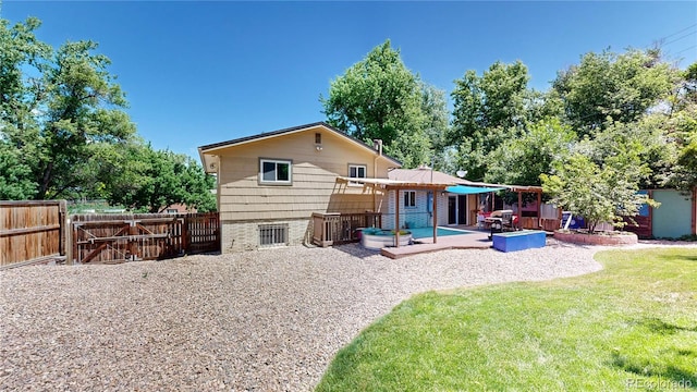 rear view of property featuring a patio area and a lawn