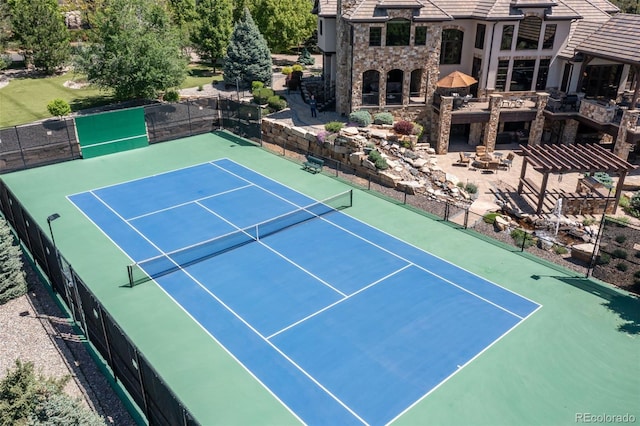 view of tennis court featuring fence