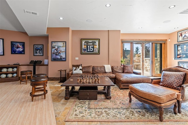 living room with stone finish flooring, baseboards, and recessed lighting