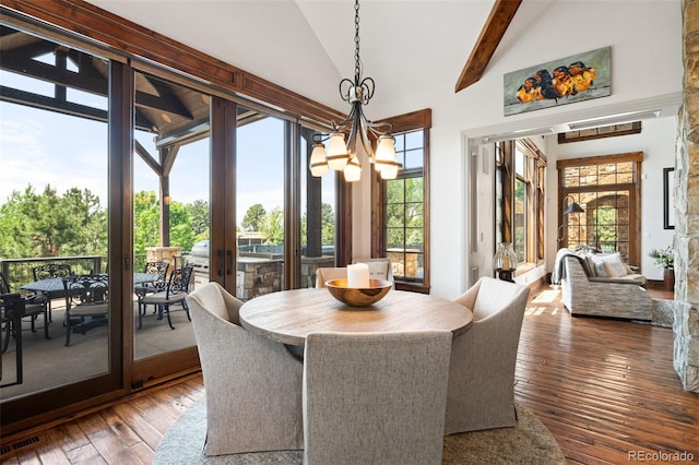 dining room featuring a chandelier, hardwood / wood-style flooring, beamed ceiling, french doors, and high vaulted ceiling