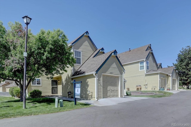10359 W Fair Ave Unit F, Littleton, CO 80127 - view of front of property with a garage, a front lawn, and concrete driveway