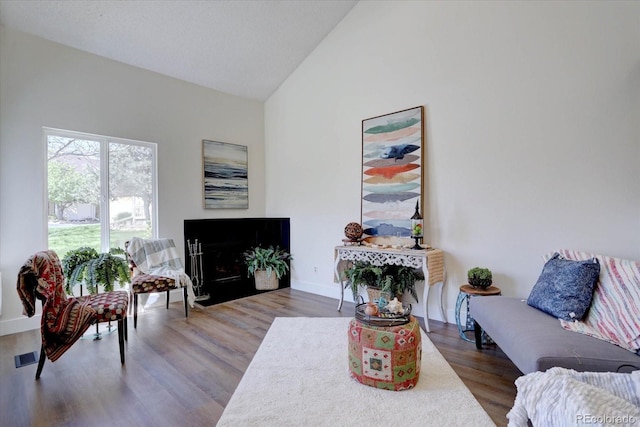 10359 W Fair Ave Unit F, Littleton, CO 80127 - living room featuring wood finished floors, high vaulted ceiling, and baseboards