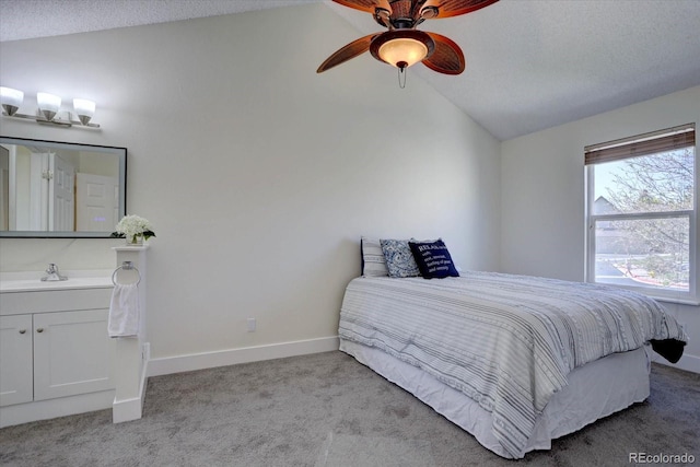 10359 W Fair Ave Unit F, Littleton, CO 80127 - bedroom with lofted ceiling, carpet, a sink, baseboards, and a ceiling fan