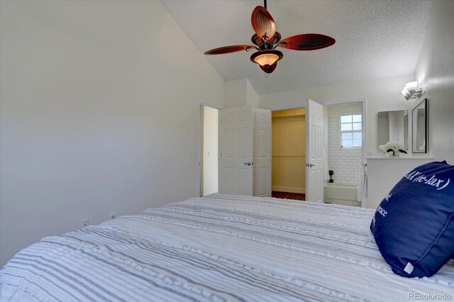 10359 W Fair Ave Unit F, Littleton, CO 80127 - bedroom with lofted ceiling, a ceiling fan, a walk in closet, and a textured ceiling
