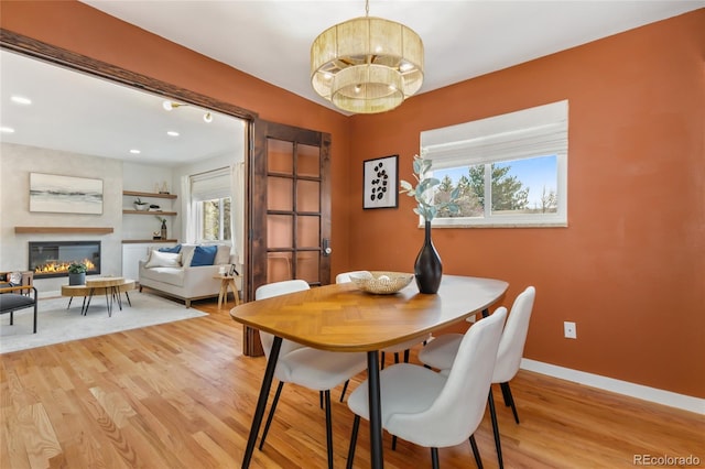 4655 Ludlow St, Boulder, CO 80305 - dining room featuring a glass covered fireplace, baseboards, a chandelier, recessed lighting, and light wood-style floors