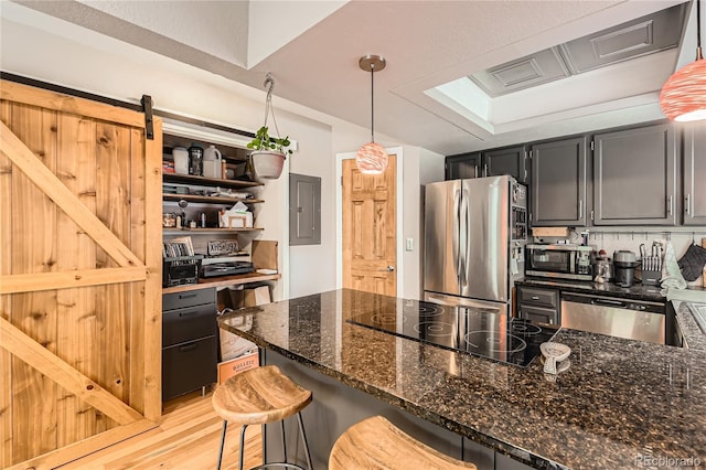 6213 Willow Ln, Boulder, CO 80301 - kitchen with appliances with stainless steel finishes, electric panel, dark stone countertops, decorative light fixtures, and light wood-type flooring