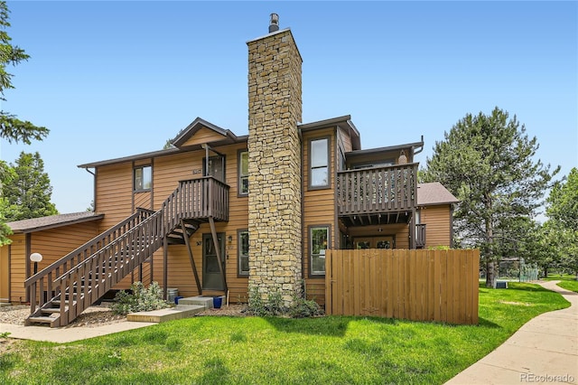 6213 Willow Ln, Boulder, CO 80301 - rear view of house featuring stairway, a balcony, and a chimney