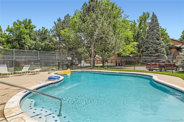 6213 Willow Ln, Boulder, CO 80301 - community pool featuring a patio area and view of wooded area