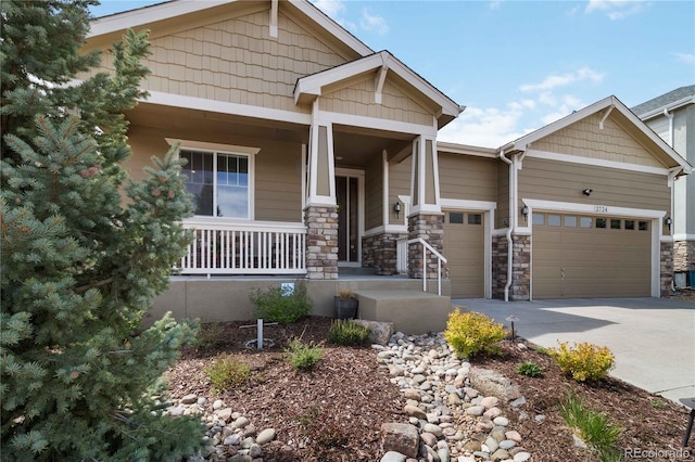 2724 Rising Moon Way, Castle Rock, CO 80109 - craftsman-style home with covered porch, an attached garage, concrete driveway, and stone siding