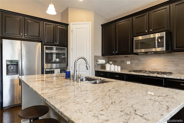 2724 Rising Moon Way, Castle Rock, CO 80109 - kitchen with appliances with stainless steel finishes, a sink, decorative backsplash, light stone countertops, and lofted ceiling