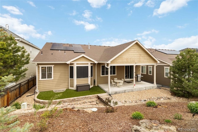 2724 Rising Moon Way, Castle Rock, CO 80109 - back of property featuring roof mounted solar panels, a fenced backyard, a patio, and roof with shingles