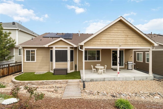2724 Rising Moon Way, Castle Rock, CO 80109 - back of house featuring roof mounted solar panels, a patio area, and roof with shingles