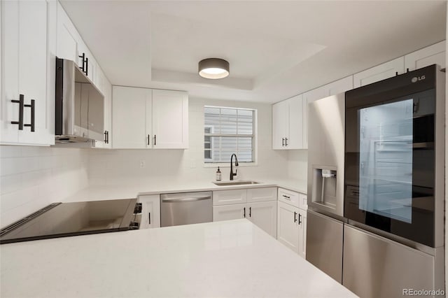 kitchen with white cabinets and appliances with stainless steel finishes