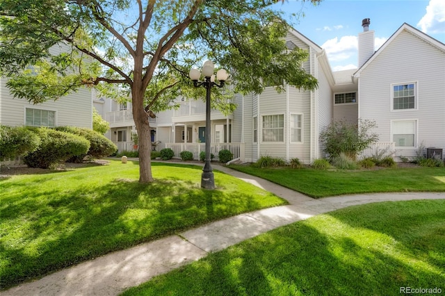 view of front of property featuring a porch, central AC, and a front lawn