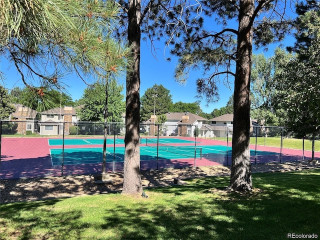 view of basketball court featuring tennis court and a yard