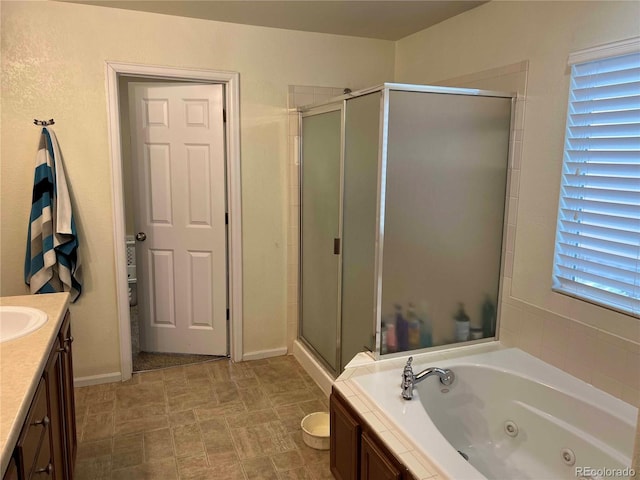 10636 Racine Cir, Commerce City, CO 80022 - bathroom featuring a healthy amount of sunlight, vanity, and independent shower and bath