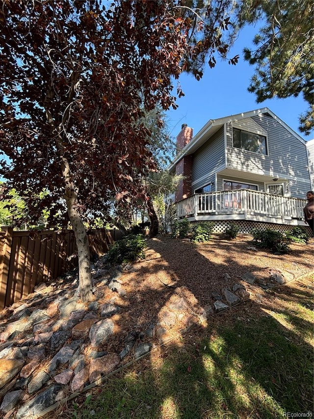 view of side of home with a wooden deck