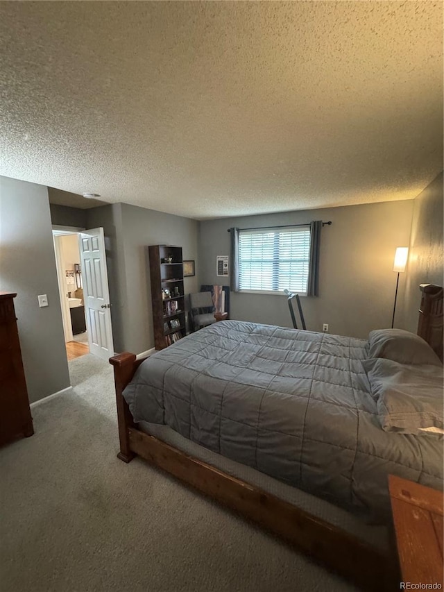 7020 W Portland Ave, Littleton, CO 80128 - bedroom featuring carpet flooring, a textured ceiling, and connected bathroom