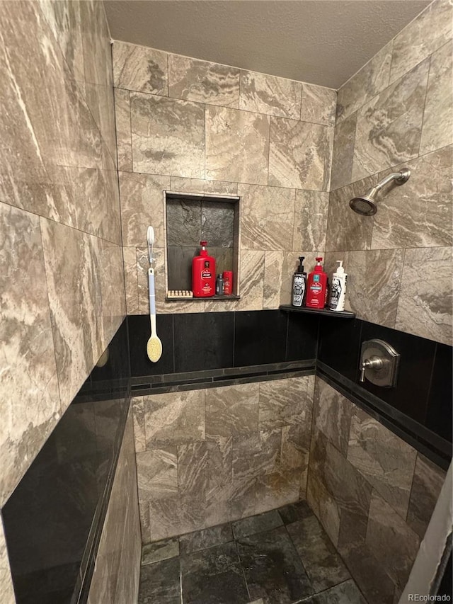 7020 W Portland Ave, Littleton, CO 80128 - full bathroom featuring a tile shower and a textured ceiling