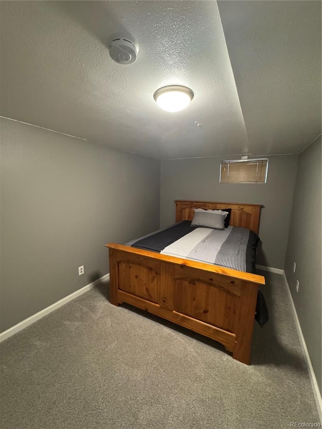 7020 W Portland Ave, Littleton, CO 80128 - carpeted bedroom with baseboards and a textured ceiling