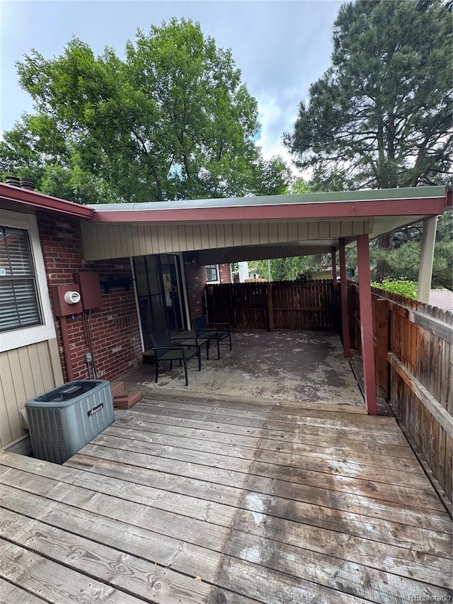 7020 W Portland Ave, Littleton, CO 80128 - wooden deck featuring an attached carport