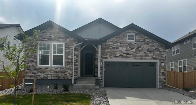 15437 Krameria St, Thornton, CO 80602 - craftsman-style home featuring an attached garage, stone siding, and concrete driveway