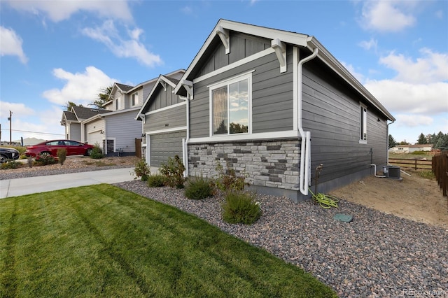 view of home's exterior with cooling unit and a yard