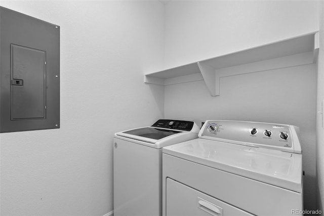 laundry area with electric panel and independent washer and dryer