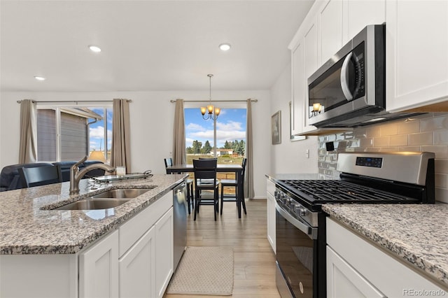 kitchen featuring light hardwood / wood-style floors, plenty of natural light, sink, and stainless steel appliances