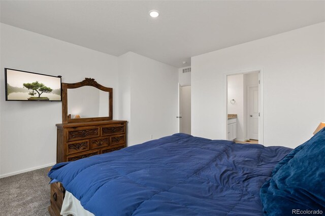 carpeted bedroom with connected bathroom