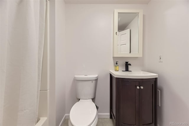 bathroom featuring tile patterned floors, vanity, toilet, and walk in shower