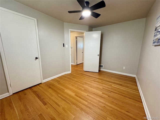 unfurnished bedroom with baseboards, ceiling fan, visible vents, and light wood finished floors