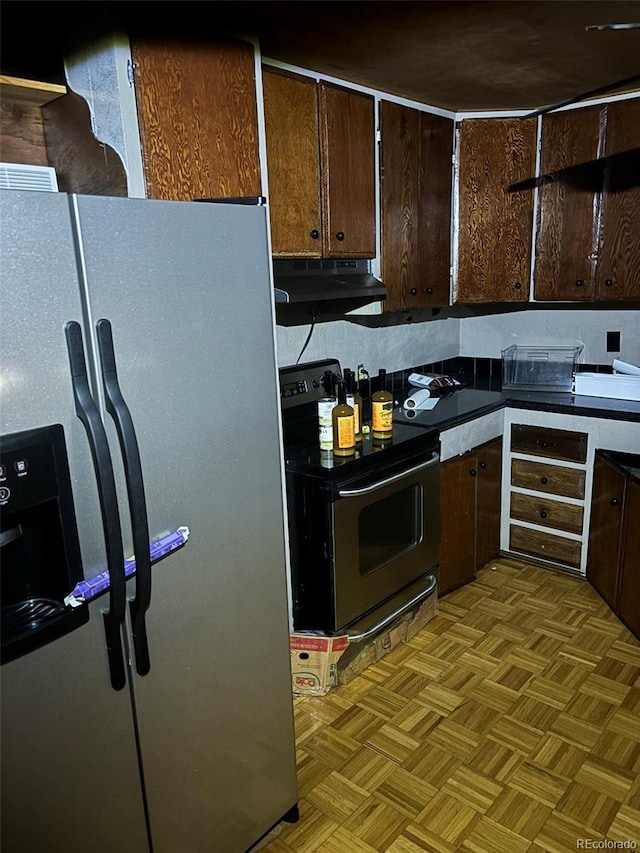 kitchen featuring dark brown cabinetry, stainless steel appliances, and light parquet flooring