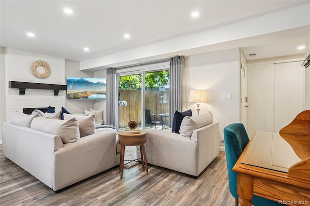 7995 E Mississippi Ave Unit F23, Denver, CO 80247 - living area with wood finished floors, recessed lighting, and a large fireplace