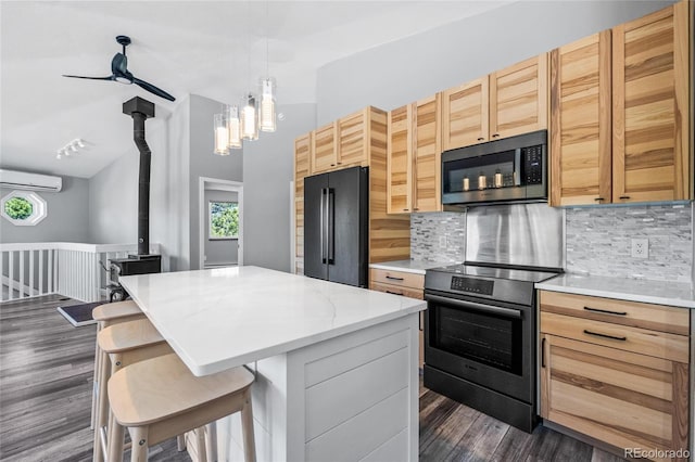 kitchen with high end black fridge, an AC wall unit, stainless steel electric range, decorative backsplash, and dark wood-style floors